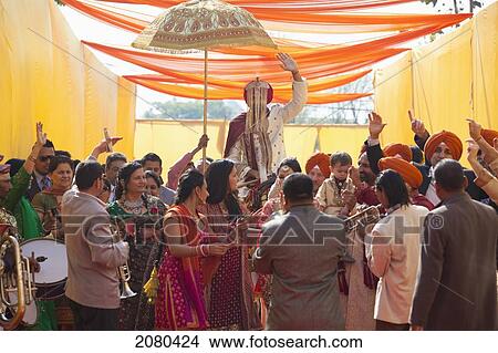 Family And Friends Greet The Groom At An Indian Wedding; Ludhiana, Punjab, India View Large Photo Image Picture - Family And Friends Greet The Groom At An Indian Wedding; Ludhiana, Punjab, India. Fotosearch