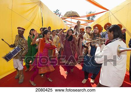 Stock Photography - Family And Friends Greet The Groom At An Indian Wedding; Ludhiana, Punjab, India. Fotosearch