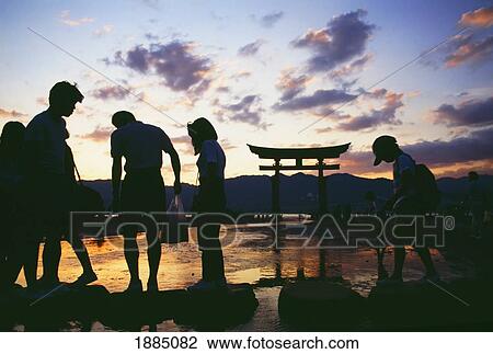 Stock Image - Family At Itsukushima Shrine At Dusk. Fotosearch