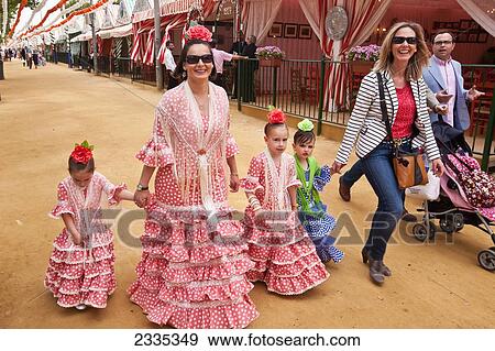 Stock Photo - Family In Traditional Dresses During April Feria Festival; Seville, Andalucia, Spain. Fotosearch