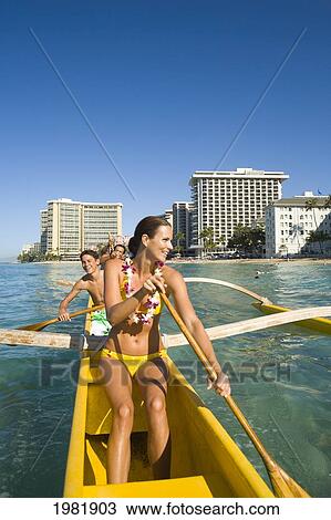 Family paddling in an outrigger canoe; Waikiki, Oahu, Hawaii, United States of America View Large Photo Image Stock Image - Family paddling in an outrigger canoe; Waikiki, Oahu, Hawaii, United States of America. Fotosearch