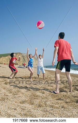 Family Playing With Ball On Beach View Large Photo Image Stock Photo - Family Playing With Ball On Beach. Fotosearch
