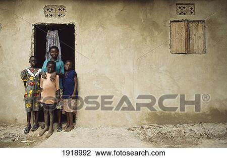 Stock Image - Family Standing Outside Their House. Fotosearch