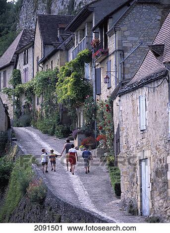 Family Walking Along Small Street In Benac Village, Dordogne Region, France. View Large Photo Image Stock Image - Family Walking Along Small Street In Benac Village, Dordogne Region, France.. Fotosearch