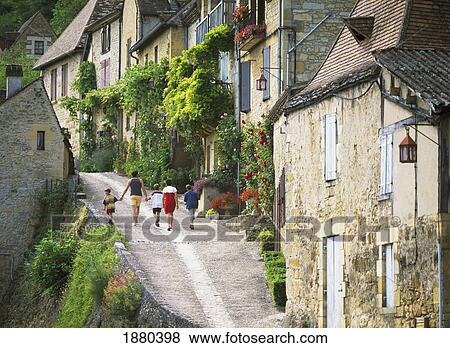 Stock Photo - Family Walking In Old Town. Fotosearch