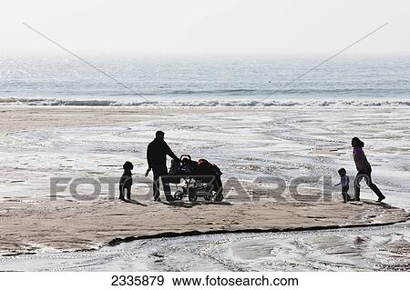 Stock Photo - Family With Dog At Manorbier Beach; Pembrokeshire Coast Path, Wales, United Kingdom. Fotosearch