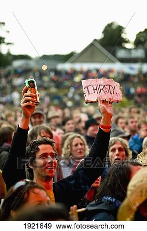 Stock Photo - Fan with beer at Green Man Festival, Glanusk Park, Brecon Beacons, Wales, UK. Fotosearch