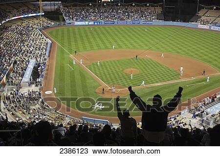 Stock Image - Fans cheering for a baseball team in a stadium; Los Angeles, California, United States of America. Fotosearch