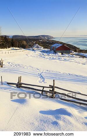 Stock Image - Farm In Winter At Sunrise In The Charlevoix Region; Port-Au-Persil Quebec Canada. Fotosearch