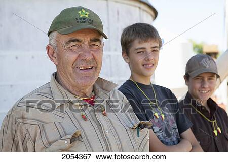Stock Photo - Farmer And His Grandsons. Munson Alberta. Fotosearch