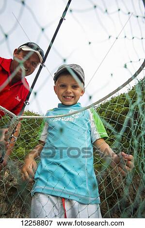 Stock Photo - Father and son fishing; Niue Island. Fotosearch