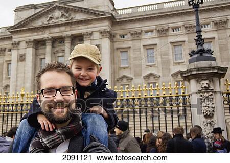 Stock Image - Father And Son Outside Buckingham Palace; London, England. Fotosearch