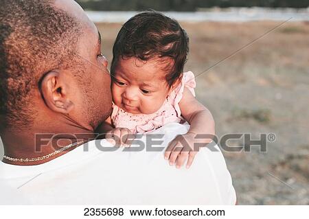 Father Holding Baby Daughter On The Beach; British Columbia, Canada View Large Photo Image Stock Photo - Father Holding Baby Daughter On The Beach; British Columbia, Canada. Fotosearch