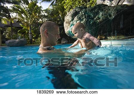Father Holding Baby In Swimming Pool; Dumaguete, Oriental s Island, Philippines View Large Photo Image Stock Photo - Father Holding Baby In Swimming Pool; Dumaguete, Oriental s Island, Philippines. Fotosearch
