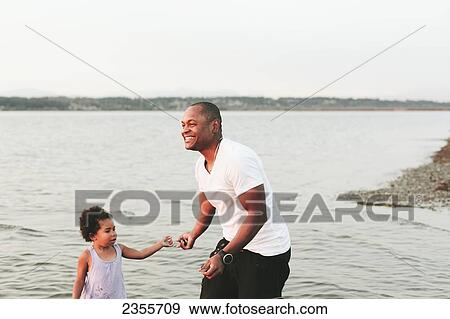 Father Wading In Water With Daughter; British Columbia, Canada View Large Photo Image Stock Photo - Father Wading In Water With Daughter; British Columbia, Canada. Fotosearch