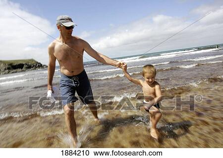 Stock Image - Father With Son On The Beach. Fotosearch