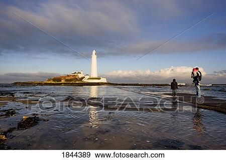 Stock Photo - Father With Two Children Watching Lighthouse; Whitley Bay, Northumberland, England. Fotosearch