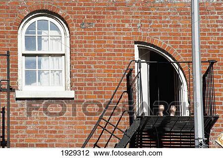 Stock Image - Feet Of Someone Relaxing In The West Village; Manhattan, New York, Usa. Fotosearch
