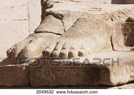 Stock Image - Feet Of The Gigantic Seated Colossus Of Ramses Ii, Once Approximately 20M High, Has Fallen To The Ground And Now Lies Face Down, In Fragments By The Temple Of Ramses Ii At The Ramesseum, Western Thebes, Qina, Egypt. Fotosearch