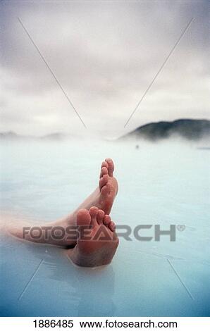Stock Photography - Feet Relaxing In Blue Lagoon, Close Up. Fotosearch
