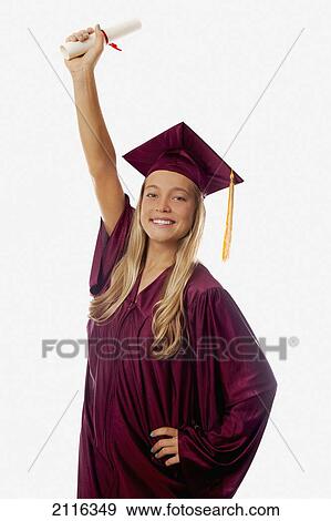 Female graduate in cap and gown, holding diploma. View Large Photo Image Stock Photo - Female graduate in cap and gown, holding diploma.. Fotosearch