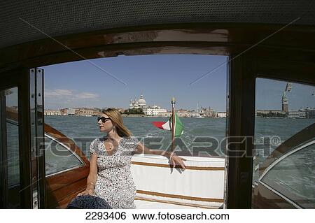 Stock Photograph - Female passenger in a water taxi; Venice. Fotosearch