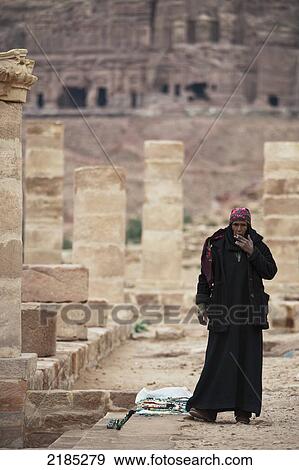 Stock Photo - Female Souvenir Seller Smoking A Cigarette At The Ancient City Of Petra, Jordan, Middle East. Fotosearch
