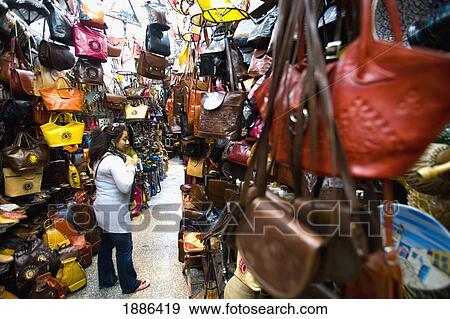 Female Tourist Buying A Leather Bag In Souq View Large Photo Image Stock Photo - Female Tourist Buying A Leather Bag In Souq. Fotosearch