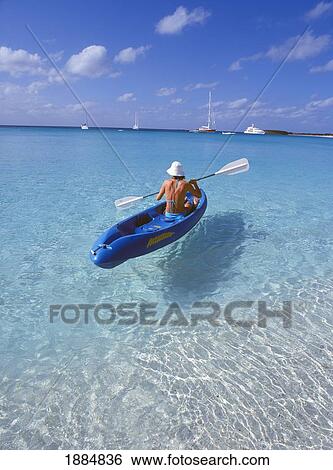 Stock Photograph - Female Tourist In Kayak On Ocean. Fotosearch