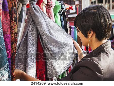 Female tourist shops for souvenirs and handmade goods at a Chinatown craft market; Victoria, Vancouver Island, British Columbia View Large Photo Image Stock Photo - Female tourist shops for souvenirs and handmade goods at a Chinatown craft market; Victoria, Vancouver Island, British Columbia. Fotosearch