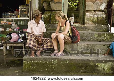 Female Tourist Sitting With Local Man View Large Photo Image Stock Image - Female Tourist Sitting With Local Man. Fotosearch