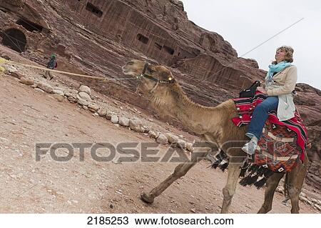 Female Tourist Taking A Camel Ride, Petra, Jordan, Middle East View Large Photo Image Stock Image - Female Tourist Taking A Camel Ride, Petra, Jordan, Middle East. Fotosearch
