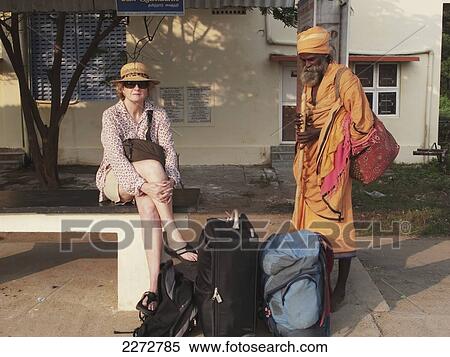 Female tourist waiting at train station and being watched by a sadhu at kanchipuram station; kanchipuram tamil nadu south india View Large Photo Image Stock Photography - Female tourist waiting at train station and being watched by a sadhu at kanchipuram station; kanchipuram tamil nadu south india. Fotosearch