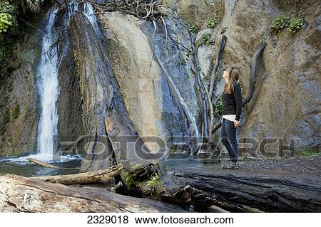 Stock Photo - Female viewing Limekiln Falls; Big Sur, Californai, United States of America. Fotosearch