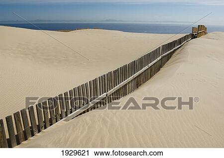Fence Cutting Through Sand On Beach; Punta Paloma, La Costa De La Luz, Spain View Large Photo Image Stock Image - Fence Cutting Through Sand On Beach; Punta Paloma, La Costa De La Luz, Spain. Fotosearch