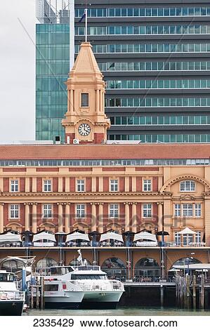 Stock Photo - Ferry Moored Near Building With Clock Tower; New Zealand. Fotosearch