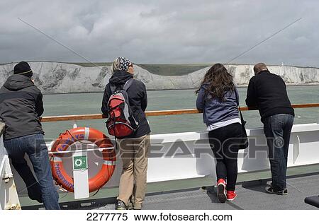 Stock Photography - Ferry Passergers On Deck Looking At White Cliffs Of Dover. Fotosearch