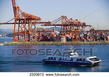 Stock Image - Ferry Passing By Cranes, Vancouver Waterfront, Harbor; Vancouver, British Columbia, Canada. Fotosearch