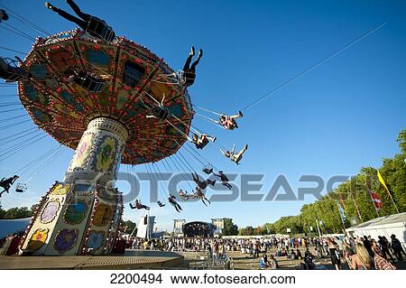 Festival Goers Having A Ride On A Waveswinger At Lovebox Festival In Victoria Park, London, Uk View Large Photo Image Picture - Festival Goers Having A Ride On A Waveswinger At Lovebox Festival In Victoria Park, London, Uk. Fotosearch