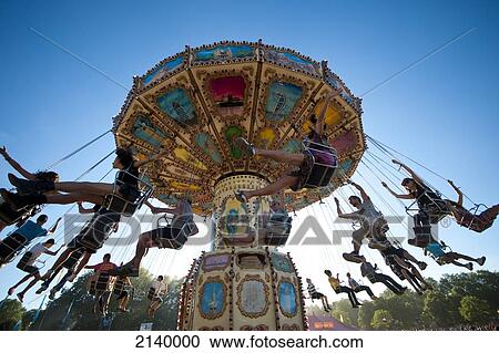 Stock Image - Festival Goers Having A Ride On A Waveswinger At Lovebox Festival In Victoria Park, London, Uk. Fotosearch