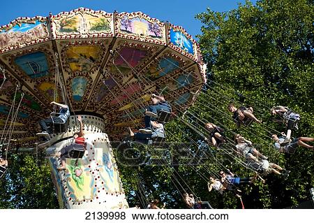 Stock Photo - Festival Goers Having A Ride On A Waveswinger At Lovebox Festival In Victoria Park, London, Uk. Fotosearch