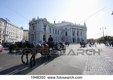 Stock Image - Fiaker (Viennese two-horse hackney carriage) by the Burgtheater (Imperial Court Theatre), Vienna, Wien, Austria. Fotosearch