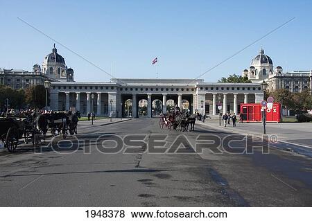 Fiaker (Viennese two-horse hackney carriage) in front of the Burgtor of the Hofburg Imperial Palace, Vienna (Wien), Austria View Large Photo Image Stock Photo - Fiaker (Viennese two-horse hackney carriage) in front of the Burgtor of the Hofburg Imperial Palace, Vienna (Wien), Austria. Fotosearch