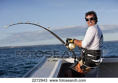 Stock Image - Fighting to reel in a bluefin tuna in the atlantic ocean; canada. Fotosearch