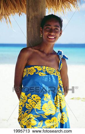 Fiji, Attractive Local Woman Wearing Pareo Standing Under Shade Along Beach, Smiling View Large Photo Image Stock Image - Fiji, Attractive Local Woman Wearing Pareo Standing Under Shade Along Beach, Smiling. Fotosearch