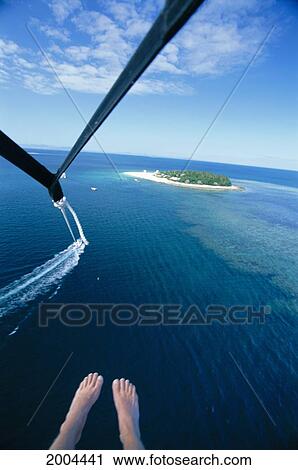Stock Image - Fiji, Beachcomber Island, Aerial From Parasail Boat Cord String And Feet Foreground Distance Background. Fotosearch