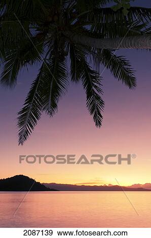 Fiji, Matangi Private Island Resort, Sunset glow over ocean. View Large Photo Image Stock Photo - Fiji, Matangi Private Island Resort, Sunset glow over ocean.. Fotosearch