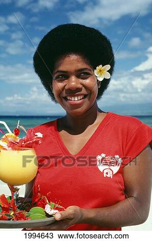Fiji, Nadi, Smiling Fijian Waitress With Colorful, Tropical Drinks View Large Photo Image Stock Image - Fiji, Nadi, Smiling Fijian Waitress With Colorful, Tropical Drinks. Fotosearch