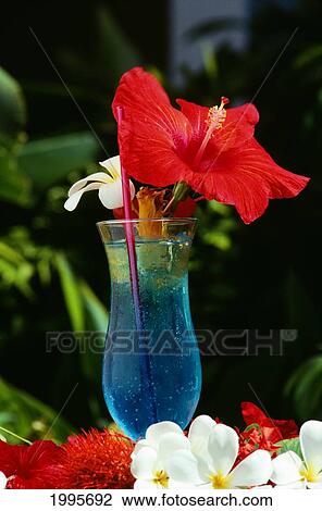 Stock Image - Fiji, The Reef Resort, Closeup Of Blue Tropical Drink With Hibiscus Garnish And Flowers. Fotosearch