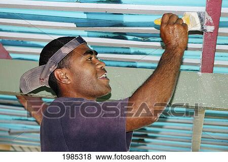 Stock Photo - Fiji, Viti Levu, Coral Coast, Fijian Man Painting. For Editorial Use Only.. Fotosearch